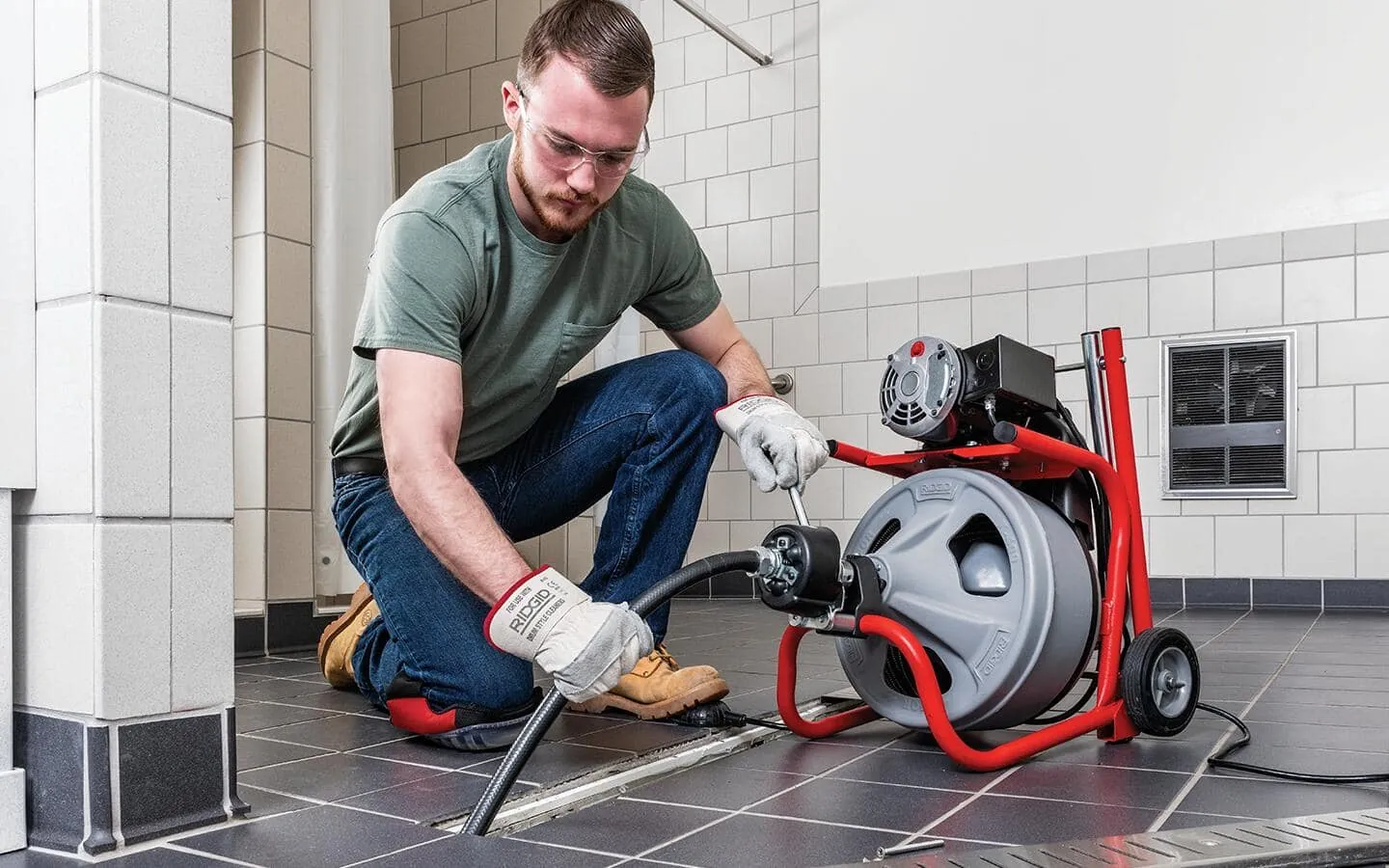 A set of drain snakes and plumbing tools neatly stored in a utility room.