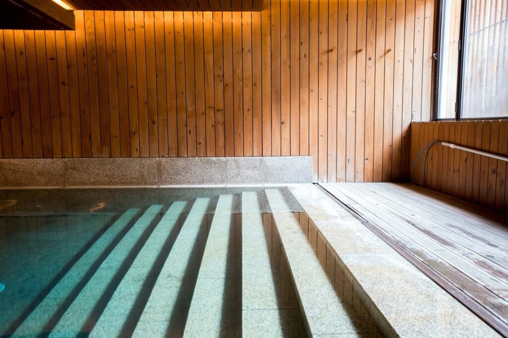 Side-by-side comparison of Hot Springs and Sundance spa construction methods in a natural setting