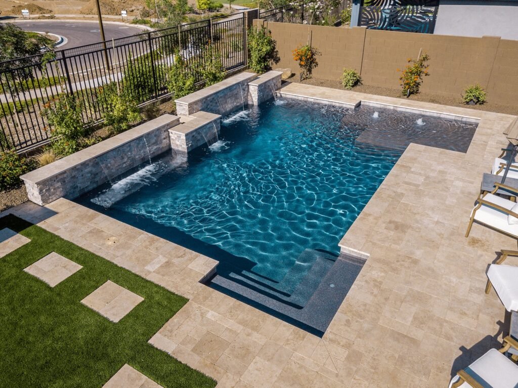 Side-by-side comparison of mini pebble and Pebble Tec pool finishes under natural sunlight