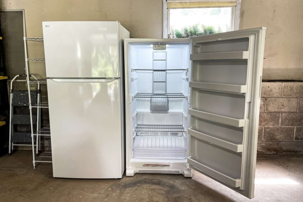 sleek modern upright freezer in a bright minimalist kitchen with stainless steel finish and digital display