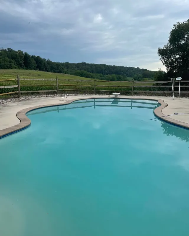 Small inflatable kiddie pool sitting alone on a green suburban lawn without chemicals.