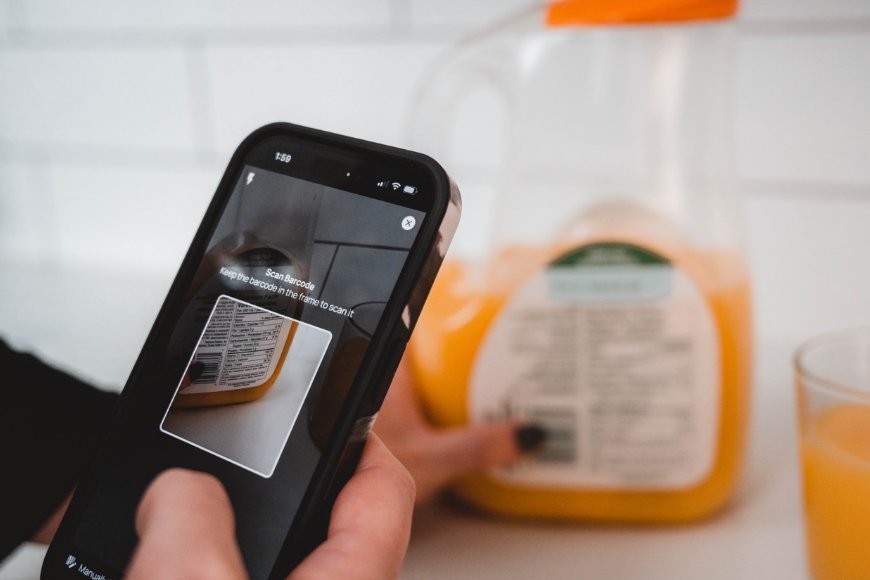 Smartphone scanning a barcode with nutrition info on a modern kitchen counter