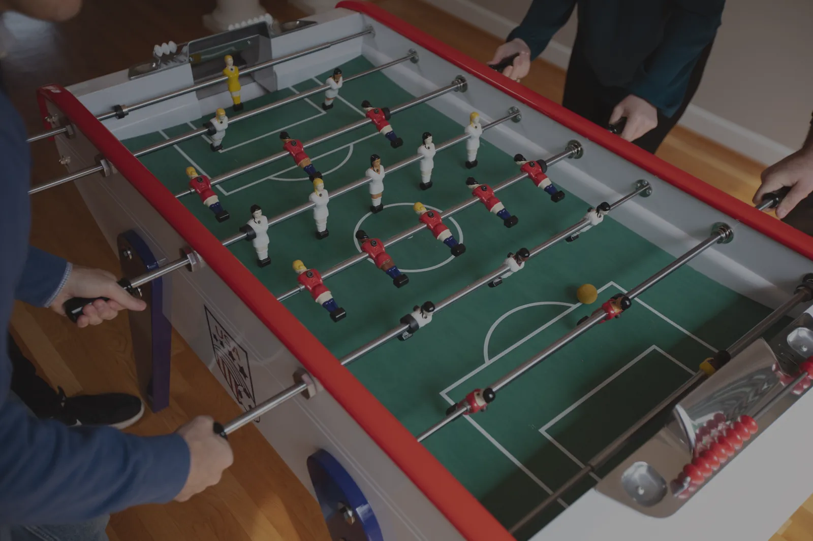 Smartphone showing slow motion foosball video next to schedule
