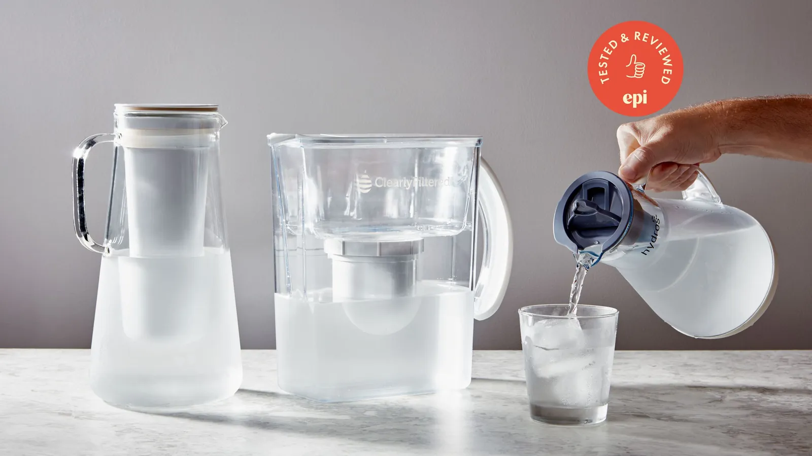 Someone pouring filtered water into a glass to demonstrate proper water filter pitcher selection.