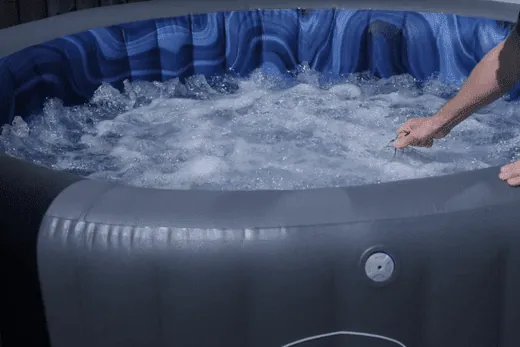Someone preparing to shock a new hot tub for the first time.