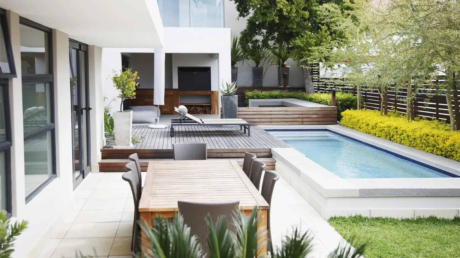 Sparkling balanced pool water with testing tools on patio.