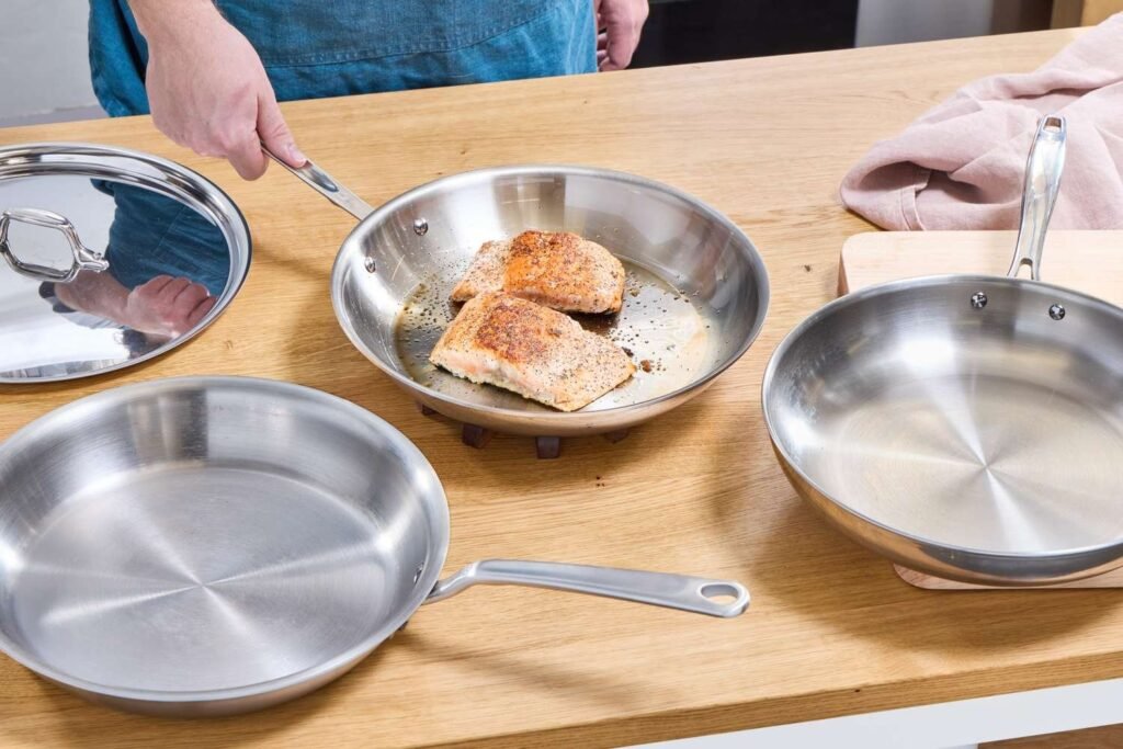 Stainless steel frying pan on oak counter in soft daylight