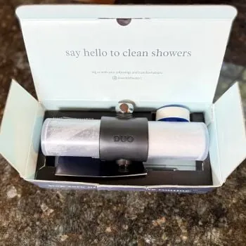 Steam rising from a high-quality shower head in a modern bathroom.