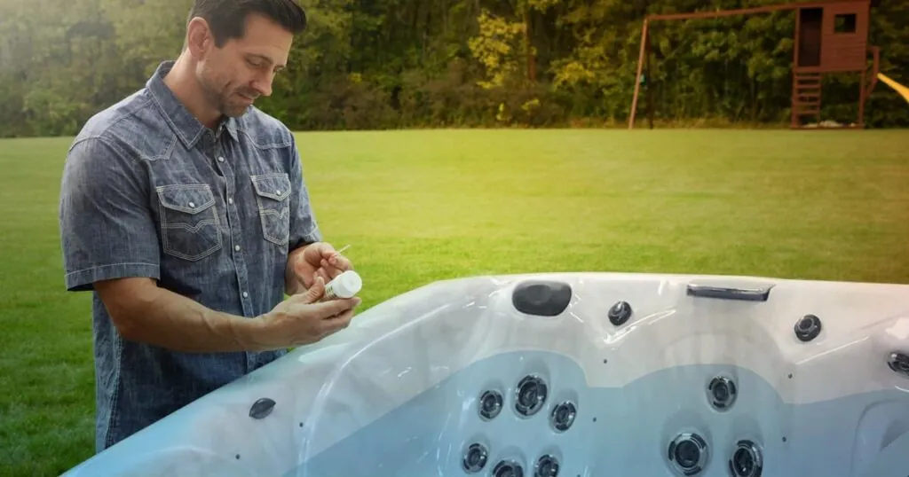 Test strips and a digital tester resting beside a backyard hot tub.