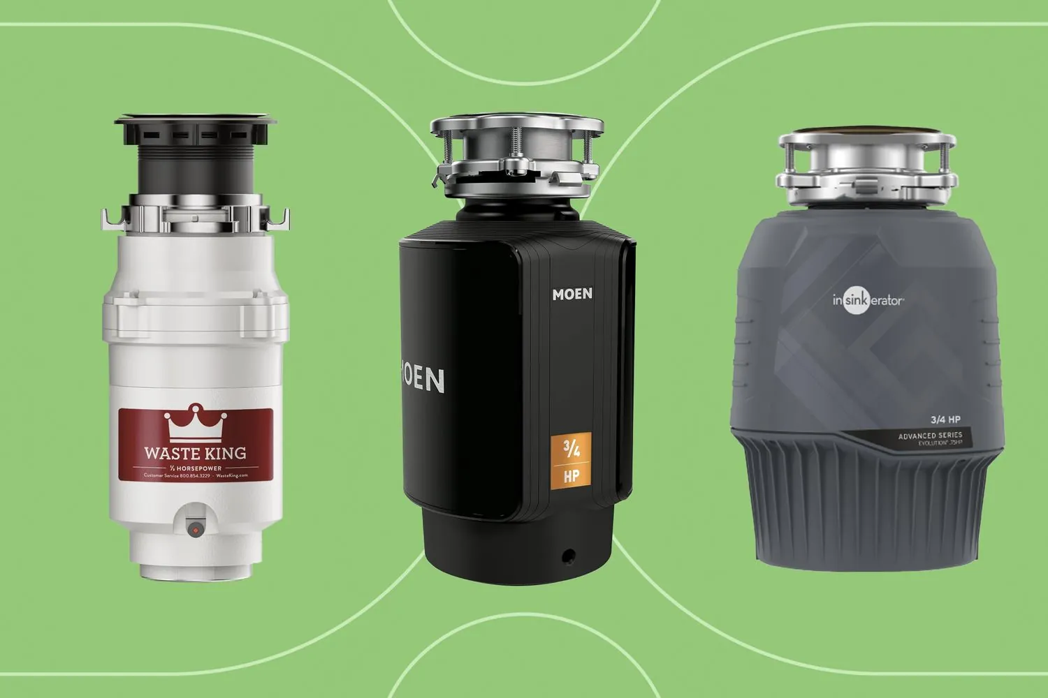 Three different sizes of garbage disposal units arranged on a workbench for size comparison.