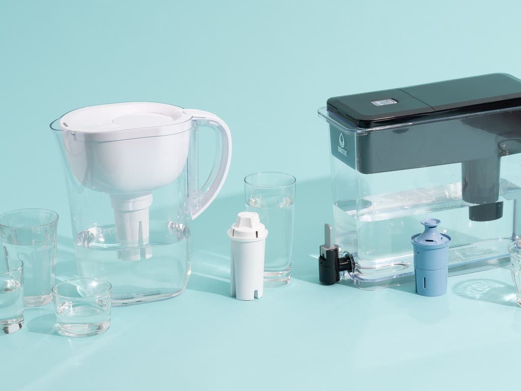 Three different water filter pitchers displayed on a modern kitchen counter for clean hydration.