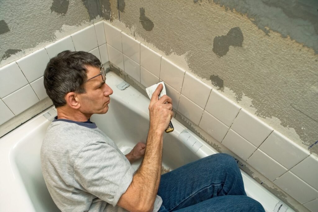 A tube of professional bathroom caulk sits on a clean tiled surface.