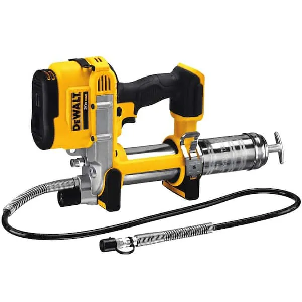 Two cordless grease guns standing upright on a wooden workshop bench.
