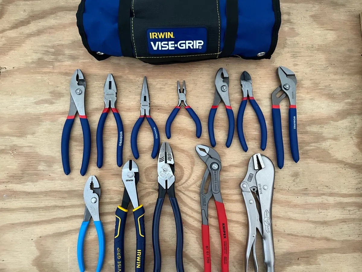 Two distinct styles of tongue and groove pliers placed on a wooden surface.