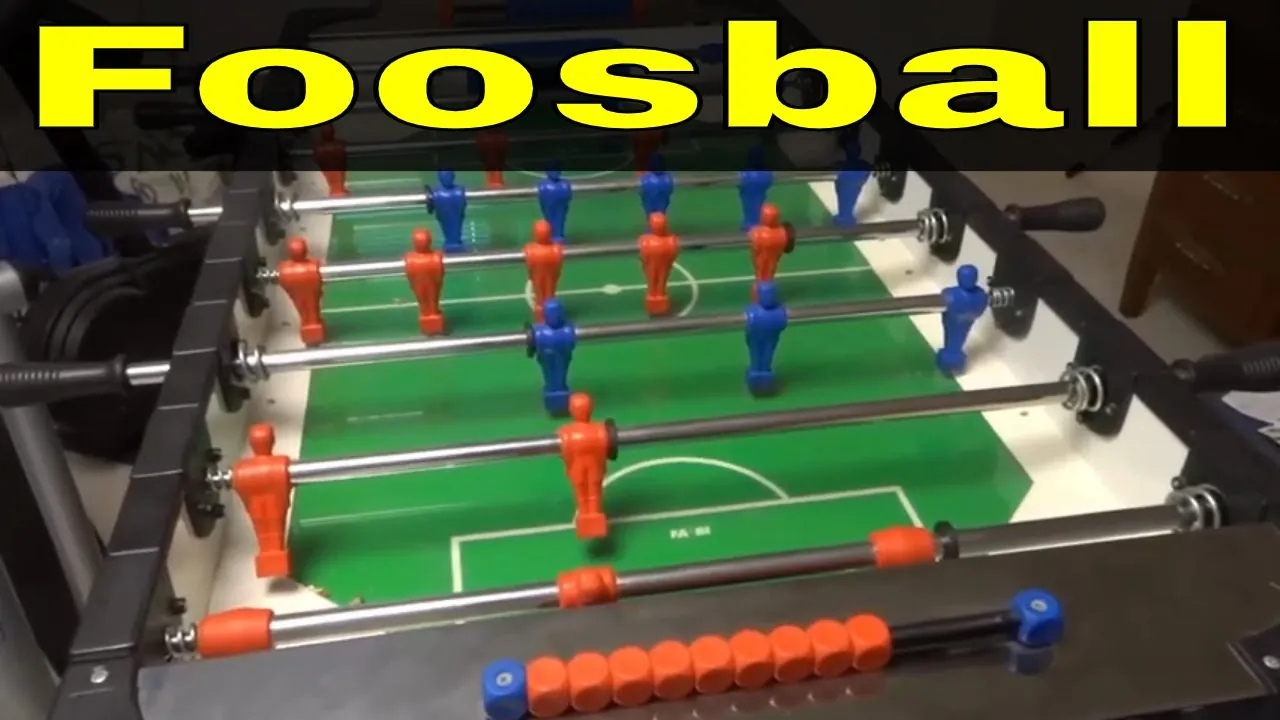 Two friends playing an intense game of foosball in a basement