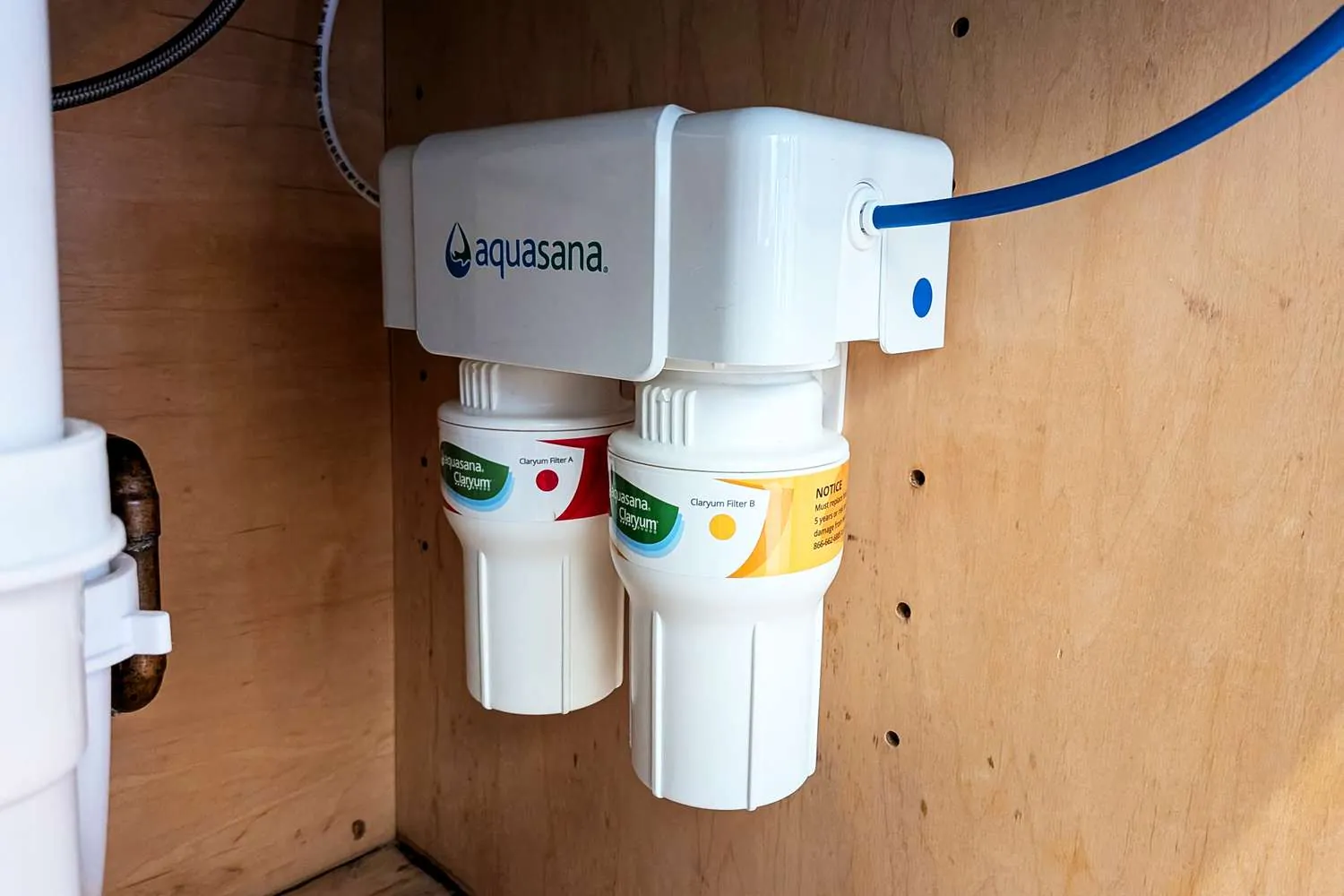 An under-sink water filter system connected to the home plumbing supply lines.