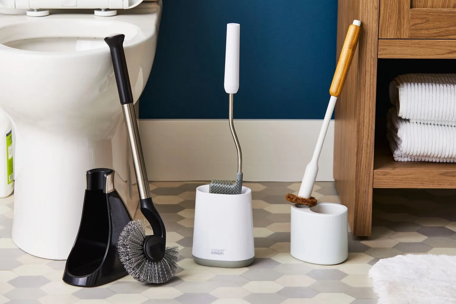 A variety of different toilet cleaning tools lined up on a wooden surface.