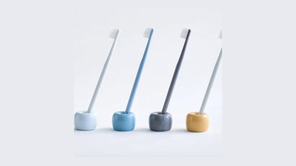 A variety of high-quality toothbrush holders displayed on a clean modern bathroom vanity.