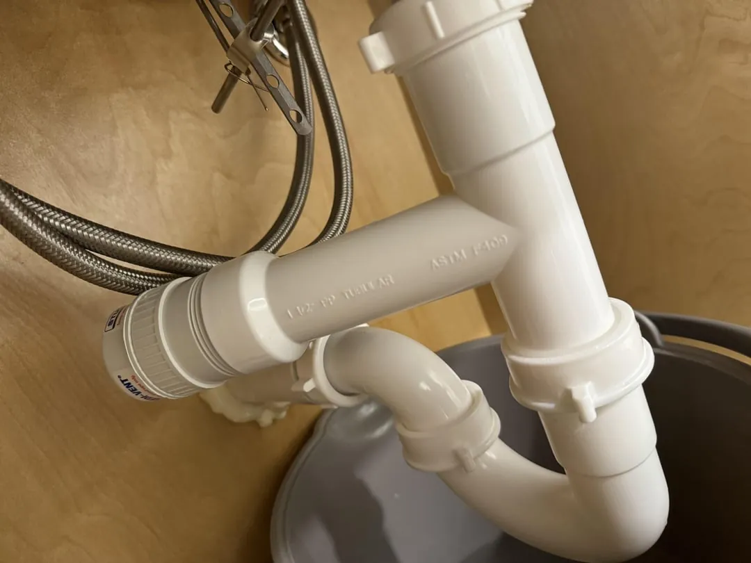 Various sizes of air admittance valves arranged in a row for comparison.