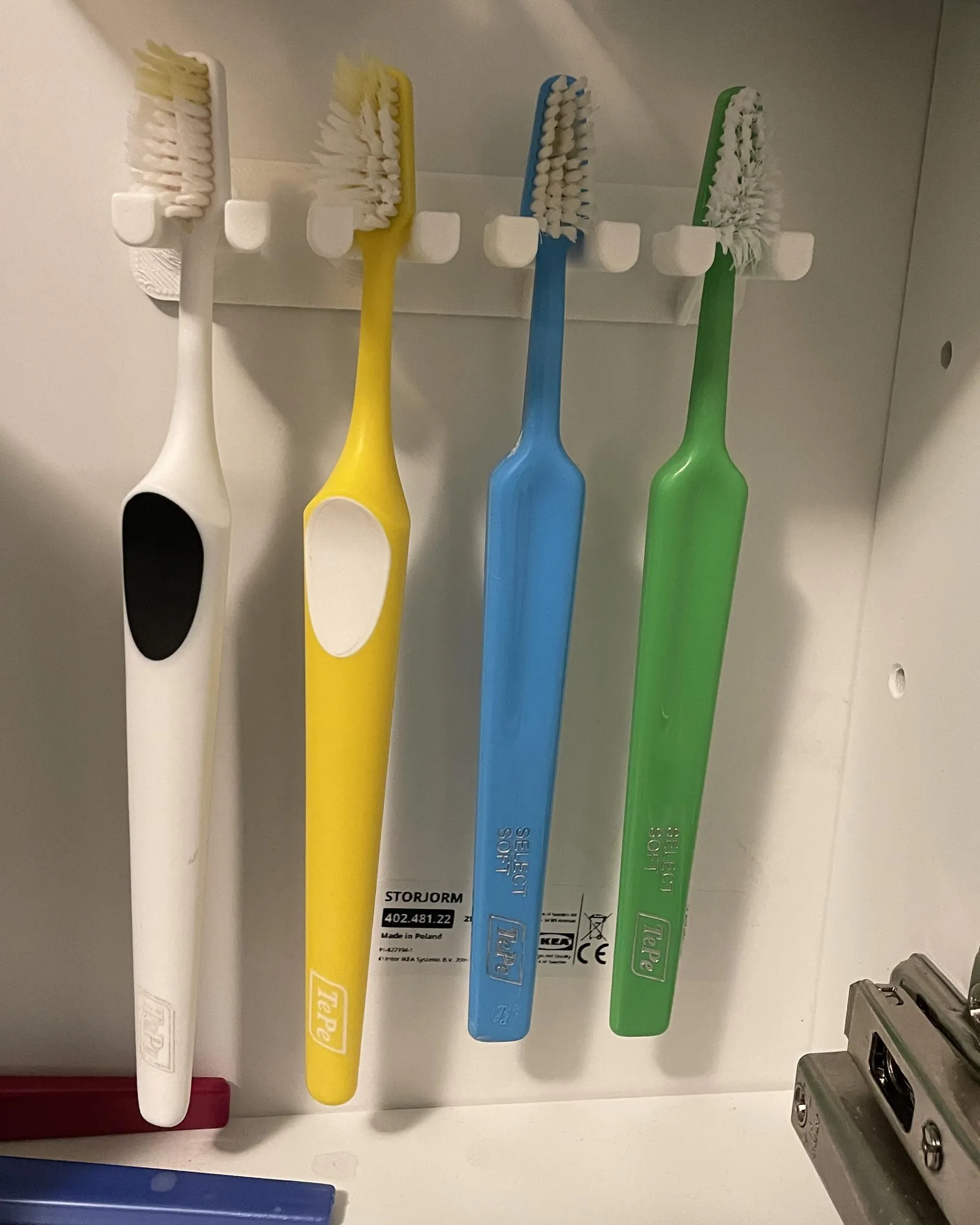 Various toothbrush holder designs displayed on a vanity to demonstrate different storage options.