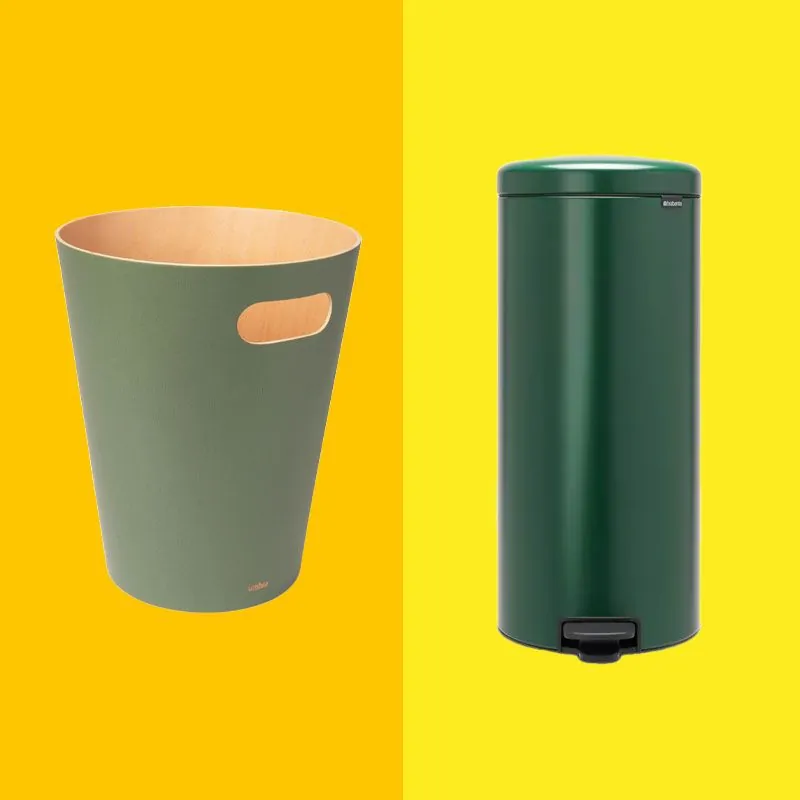 A wall-mounted trash bin installed inside a bathroom vanity cabinet door.