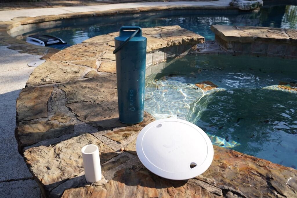 WaterGuru and Sutro pool monitors floating together in clear blue water