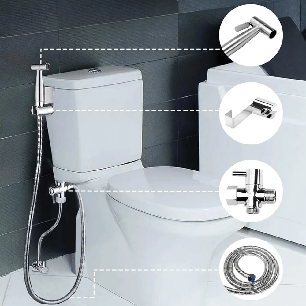 A white plastic ABS handheld bidet sprayer being held in a bathroom.