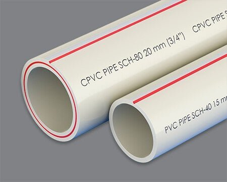 A white PVC pipe and a cream-colored CPVC pipe displayed side by side.