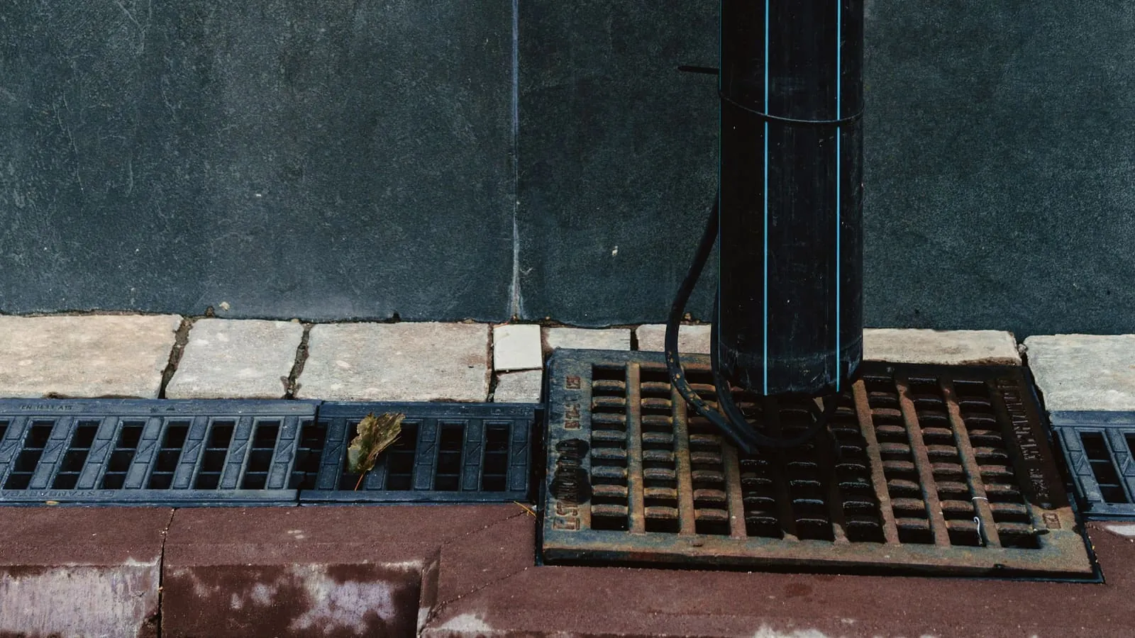 A wireless leak sensor placed near a washing machine to detect water damage.